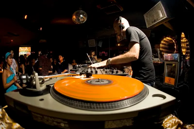 Calle 12 (Santanera area) at night on 5th Avenue Playa del Carmen — the main nightlife strip with Coco Bongo, Mandala, and La Santanera