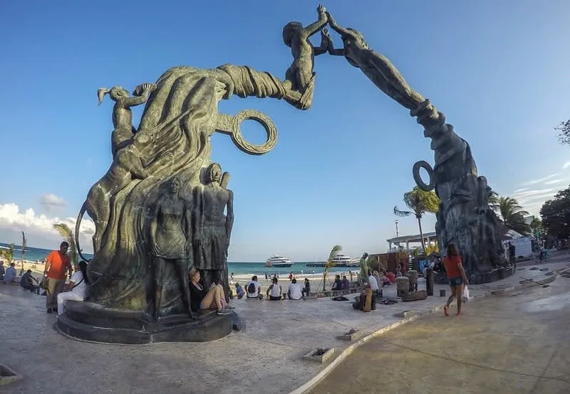 The Mayan Portal sculpture at Plaza Fundadores on 5th Avenue Playa del Carmen — 16-meter bronze arch by Arturo Tavares Padilla