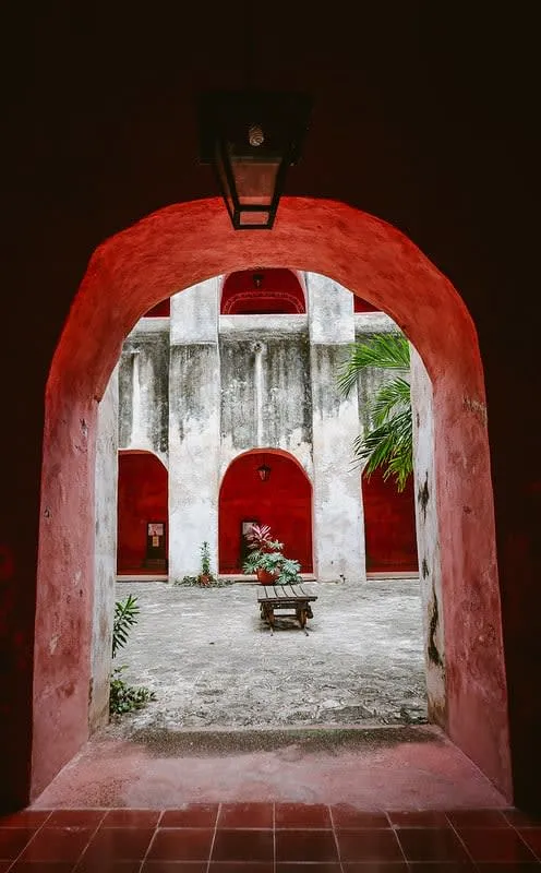 Stone convent wall with arched openings and a small bell tower
