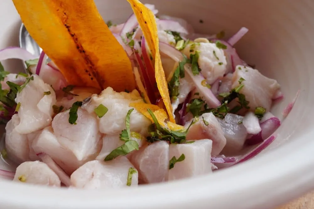 Bowl of shrimp aguachile with cucumber, red onion, lime, and green chile sauce