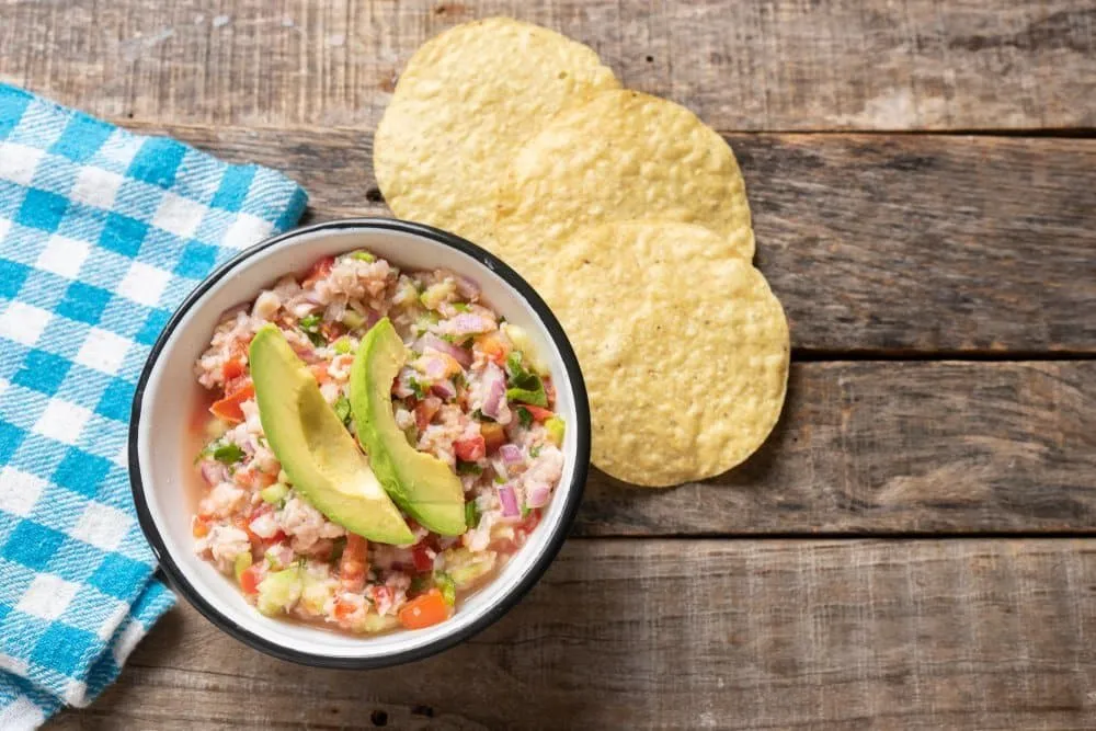 Mexican ceviche served with seafood, citrus, tomato, onion, and fresh herbs