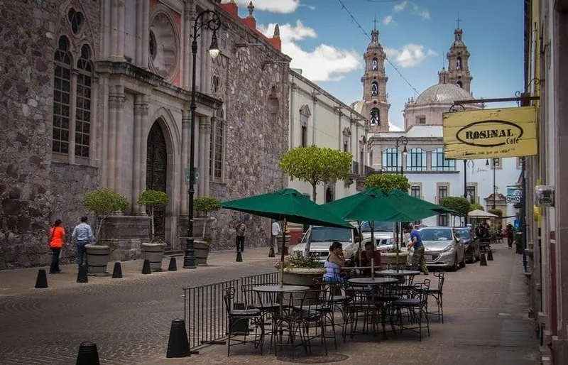 Warm March light over Aguascalientes rooftops and church towers in the historic center