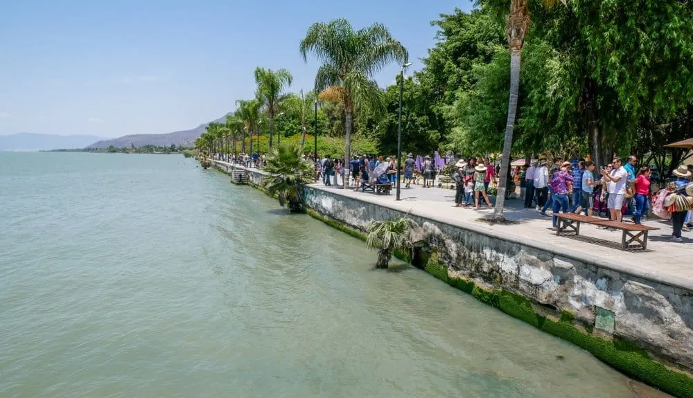 Ajijic Mexico Malecón boardwalk at sunset with Lake Chapala and mountain backdrop