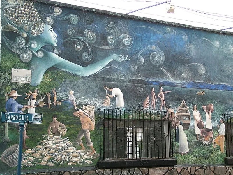 Traditional Mexican mural artwork on a whitewashed wall in Ajijic cobblestone street