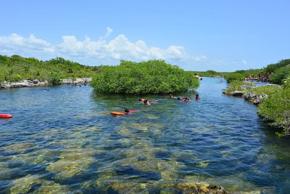 White sand beach at Akumal Mexico with calm turquoise Caribbean water and beach chairs