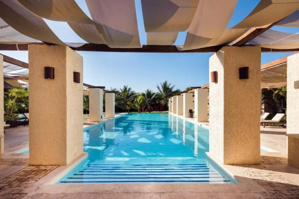 Grand Palladium White Sand resort pool and palm-lined grounds