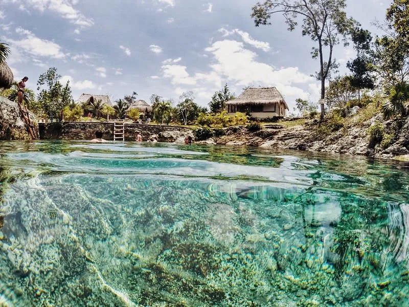 Cenote Santa Cruz near Akumal Beach Mexico with crystal clear freshwater and stalactites