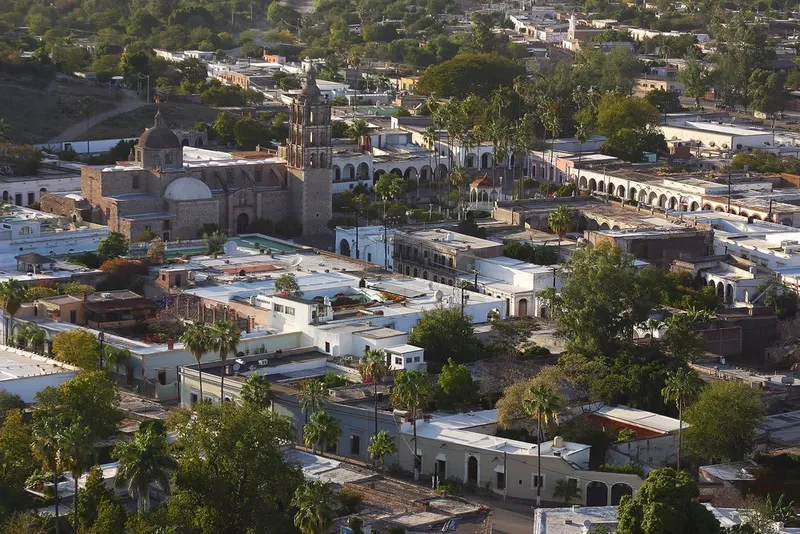Álamos Sonora town center with surrounding sierra — habitat for military macaws and migratory birds