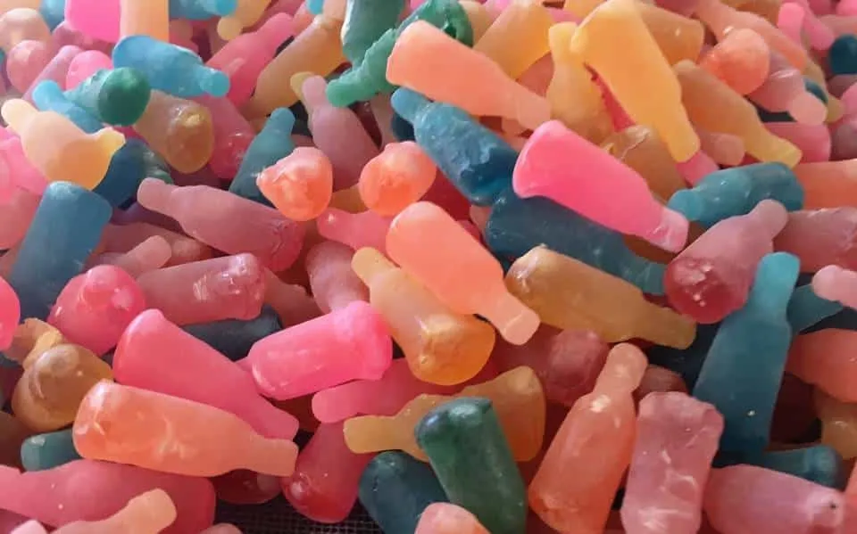 Colorful aniseed bottle candies shaped like tiny glass flasks