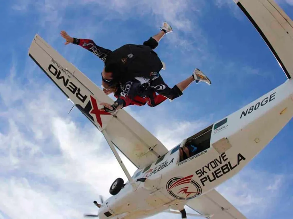 Tandem skydiver descending over the fields near Atlixco