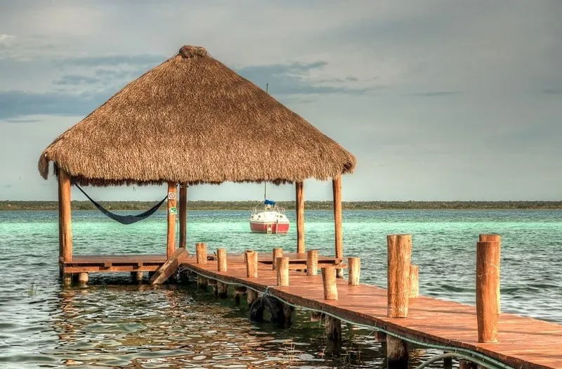 Bacalar waterfront hotel dock in December with dry-season weather and blue lagoon views