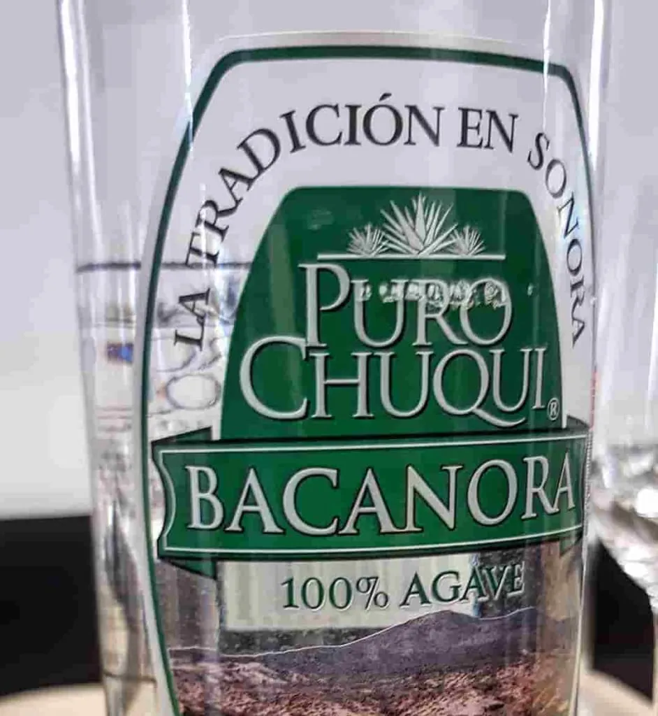 Labeled bacanora bottle showing the clear Sonoran agave spirit