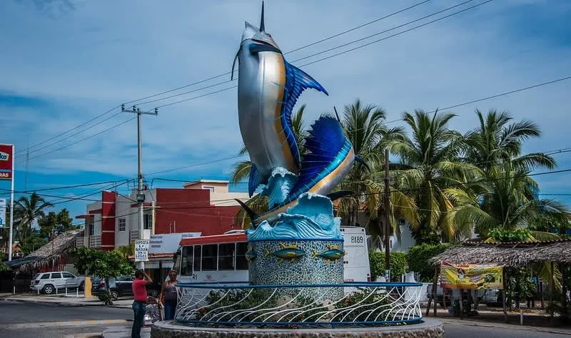 Barra de Navidad village on the Jalisco Costa Alegre — colorful fishing boats docked at the lagoon-side malecon