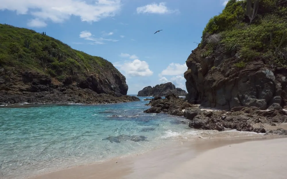 Isla Cocinas beach in Chamela Bay with clear shallow water