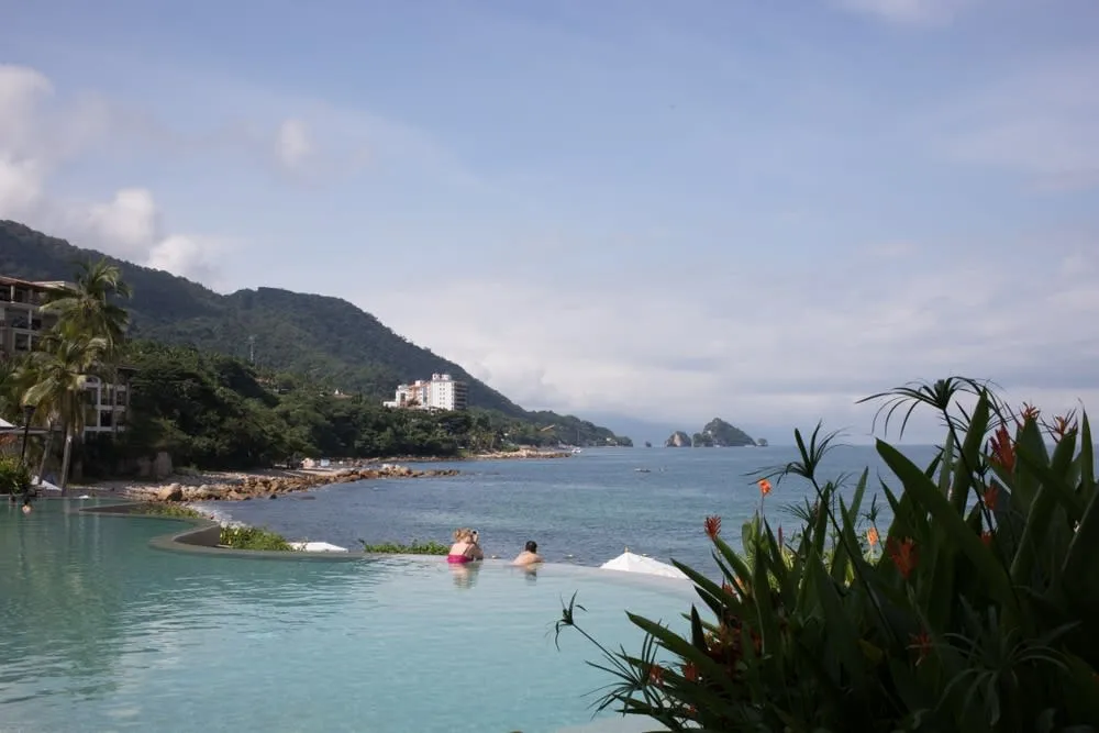 Garza Blanca Beach with blue water and green hills south of Puerto Vallarta