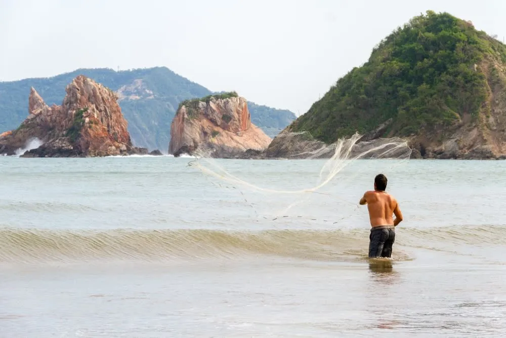 San Patricio Melaque beach with fishing boats and Bahía de Navidad water