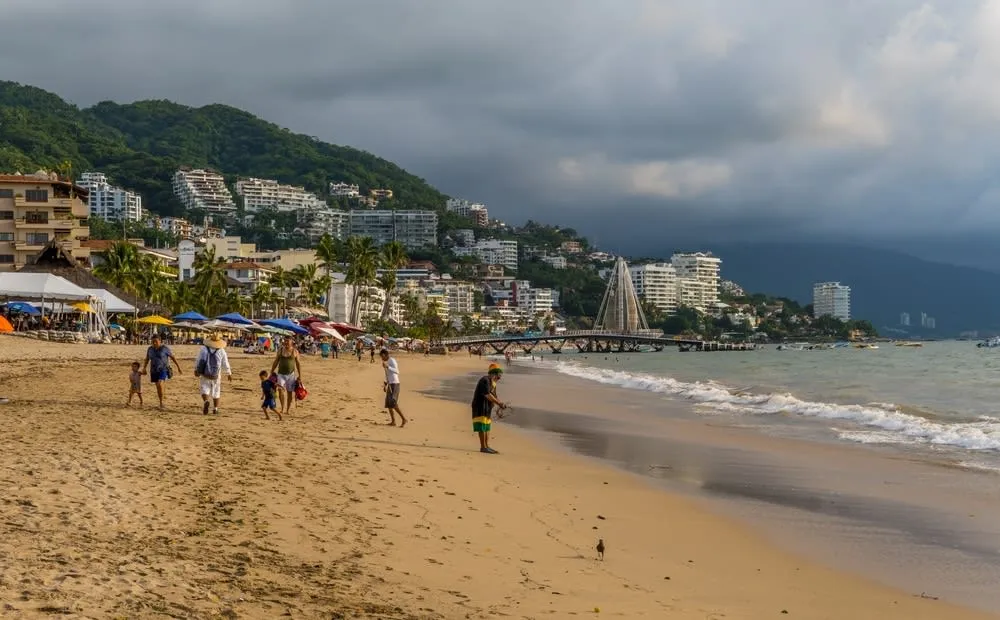 Los Muertos Beach in Puerto Vallarta with umbrellas and bay views