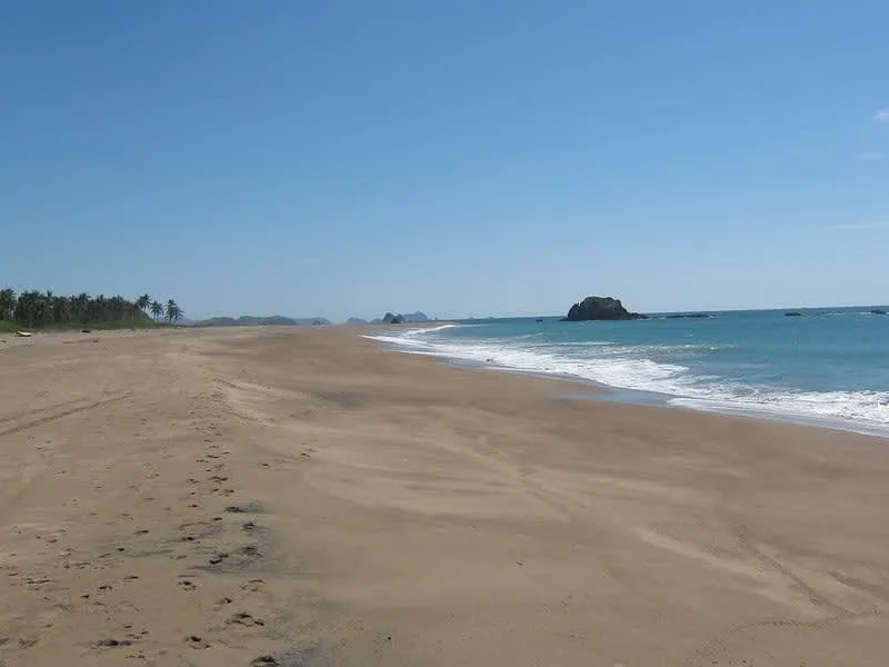 El Tecuan beach with open golden sand and strong Pacific waves