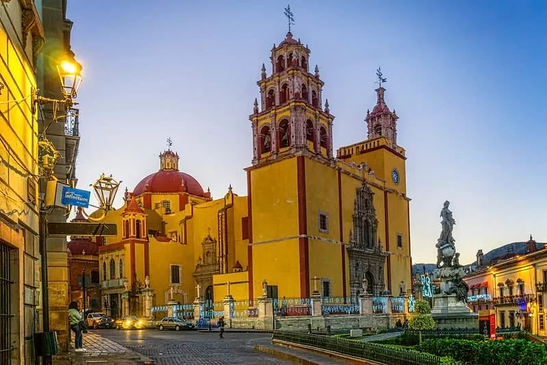 Colorful hillside city with a church tower rising above the rooftops