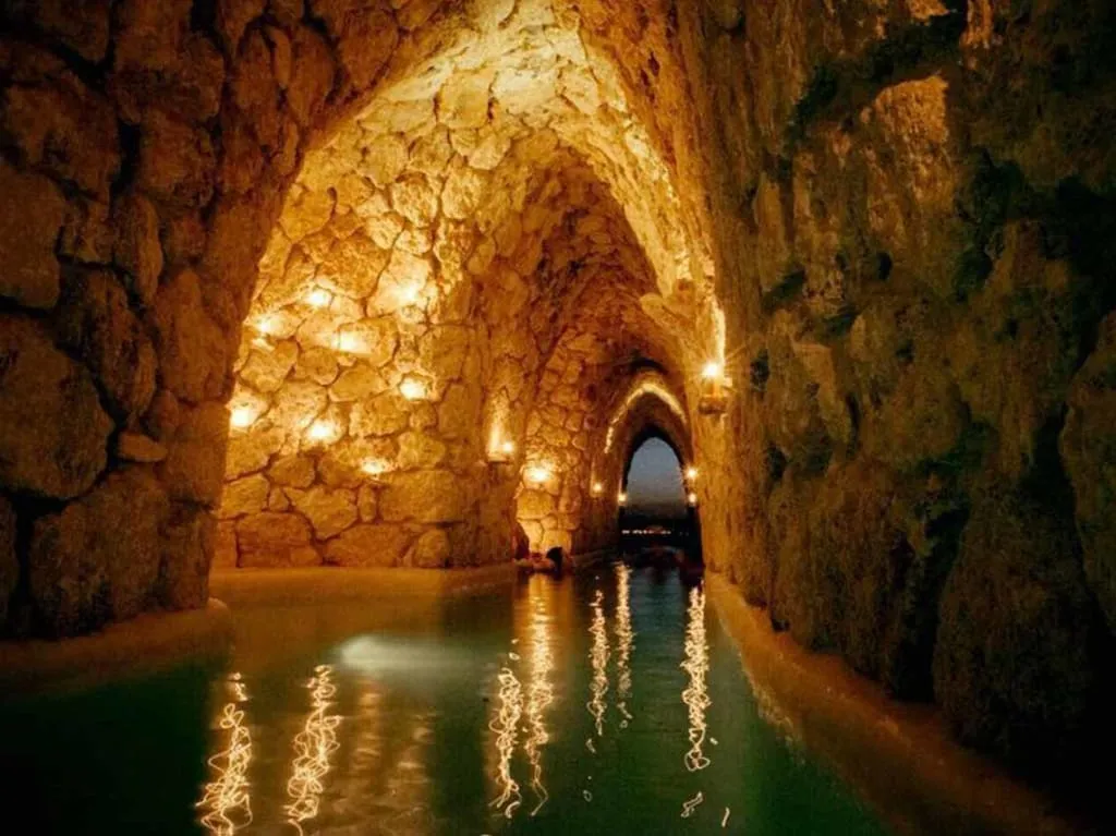 Interior of Mayan Baths San Miguel de Allende — thermal pool at 40 degrees Celsius inside a tunnel with candlelight