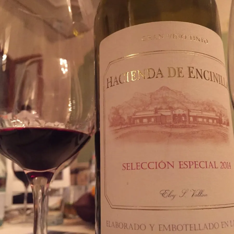 Red wine bottle and partially filled glass