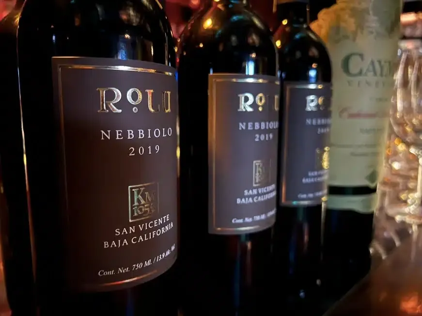 Several wine bottles lined up on a table