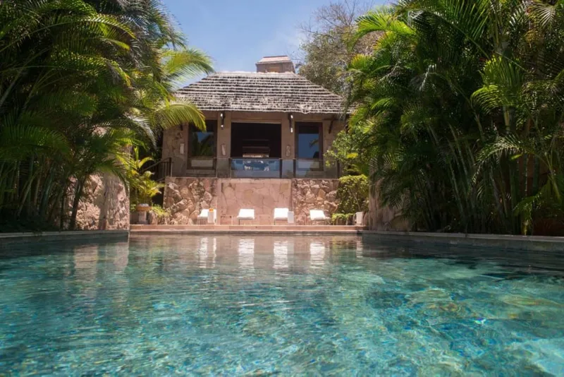 Punta Mita resort pool and beach loungers facing the Pacific