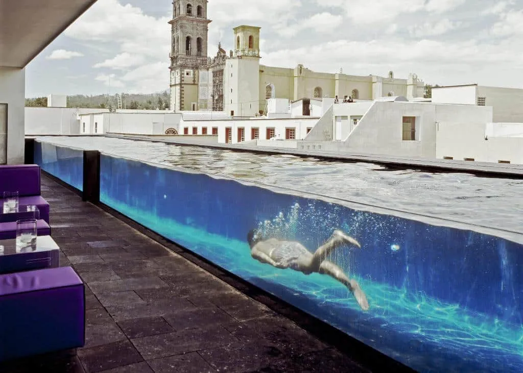 La Purificadora Puebla spa and pool area inside a restored modern hotel courtyard