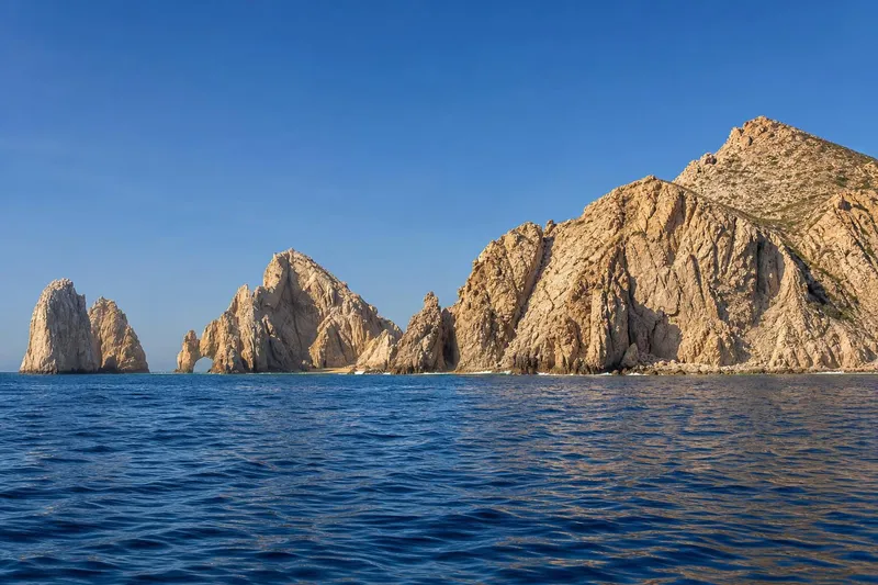 El Arco and rocky coastline off Cabo San Lucas during hot August weather
