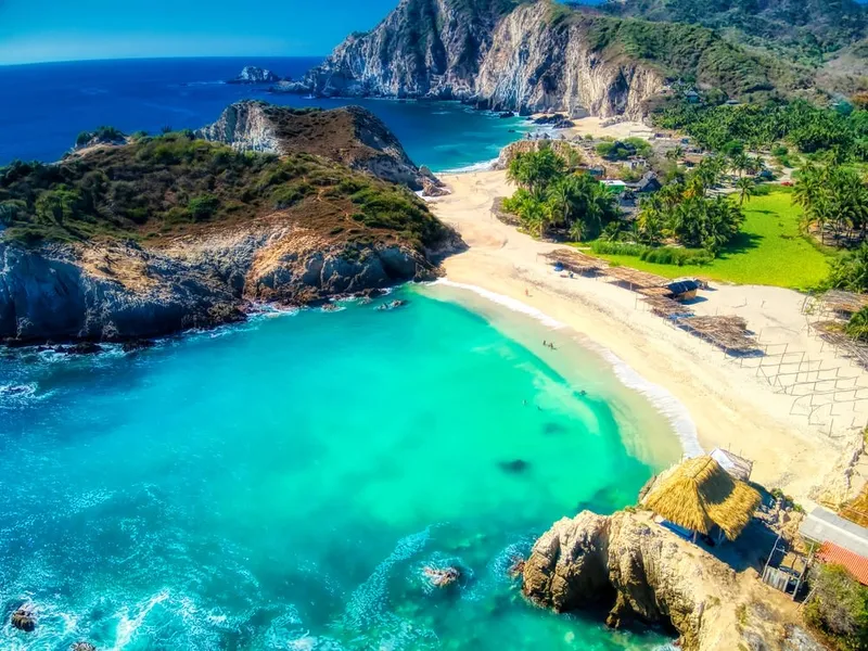 Golden sand beach with rock formations at Maruata, Michoacán