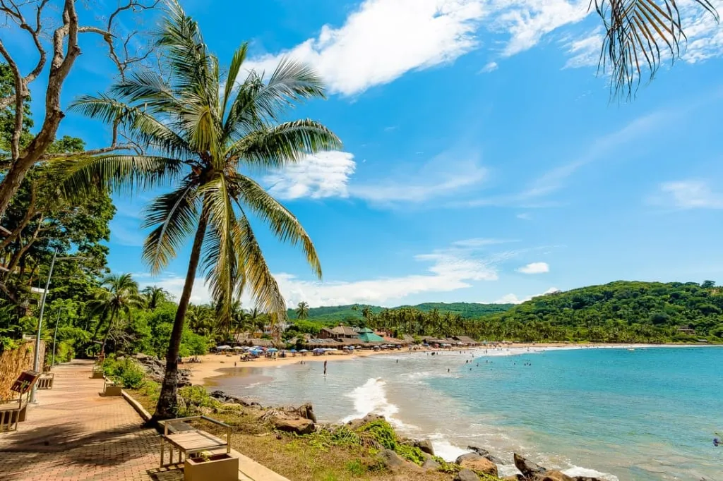 Chacala beach cove with fishing boats, palms, and green hills
