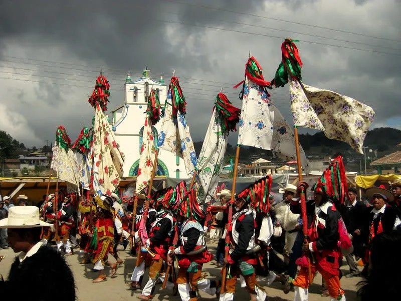 Traditional Tzotzil Maya ceremony at San Juan Chamula with costumed participants in colorful dress