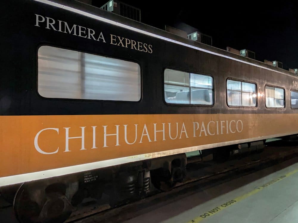 El Chepe train on a bridge over a deep gorge in the Sierra Tarahumara with canyon walls visible