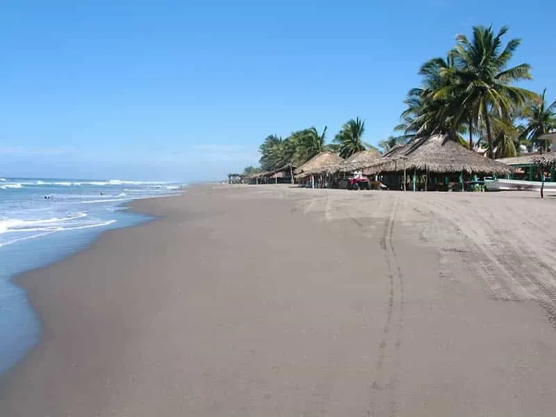 Calm blue water and palapas at Costa Azul near Puerto Arista
