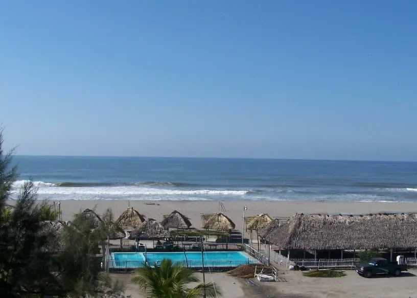 Playa Linda shoreline with golden sand and strong Pacific waves