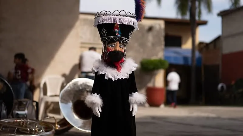 Chinelos dancers at a festival in Morelos — the traditional embroidered velvet costumes with tall feathered headdresses