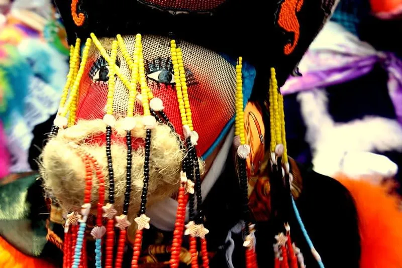 Chinelos folk dancers — male performers in long embroidered robes with painted masks and feathered hats during the traditional Morelos dance
