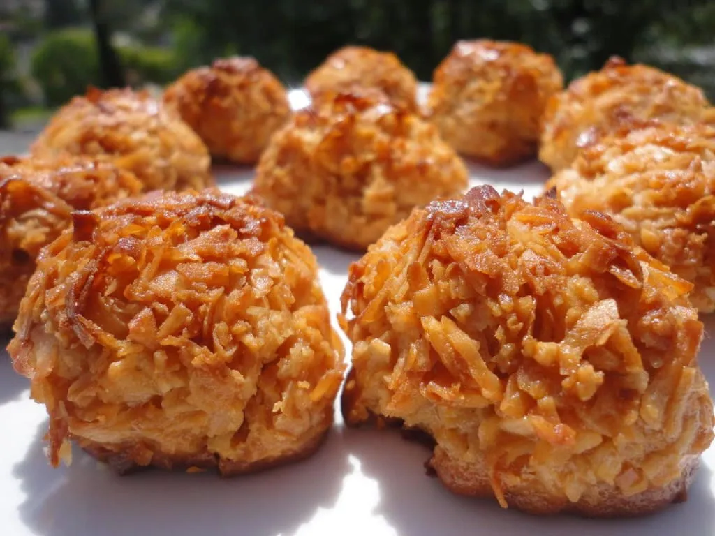 Golden coconut cocadas arranged in rows after baking