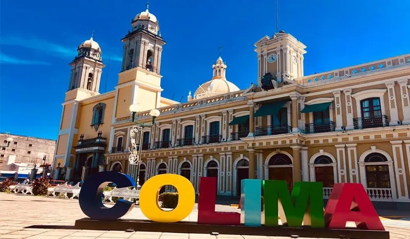 Central Colima street with palms and bright April dry-season light