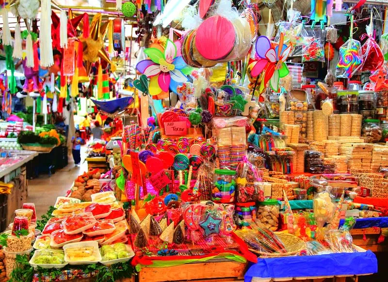 Colorful market stall filled with candies, snacks, and hanging decorations