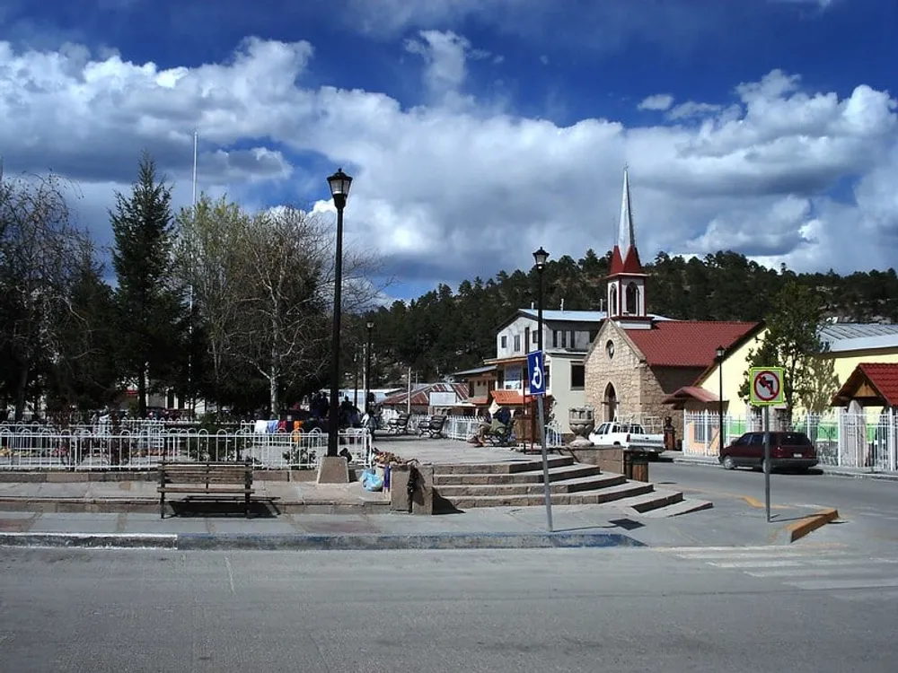 Creel Chihuahua town plaza with pine trees and Sierra Tarahumara mountains visible in the background