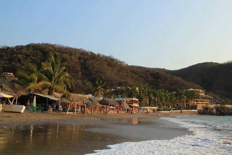 Cuastecomates beach near Barra de Navidad — protected rock cove with calm clear water and palapa restaurants, 5 km from town