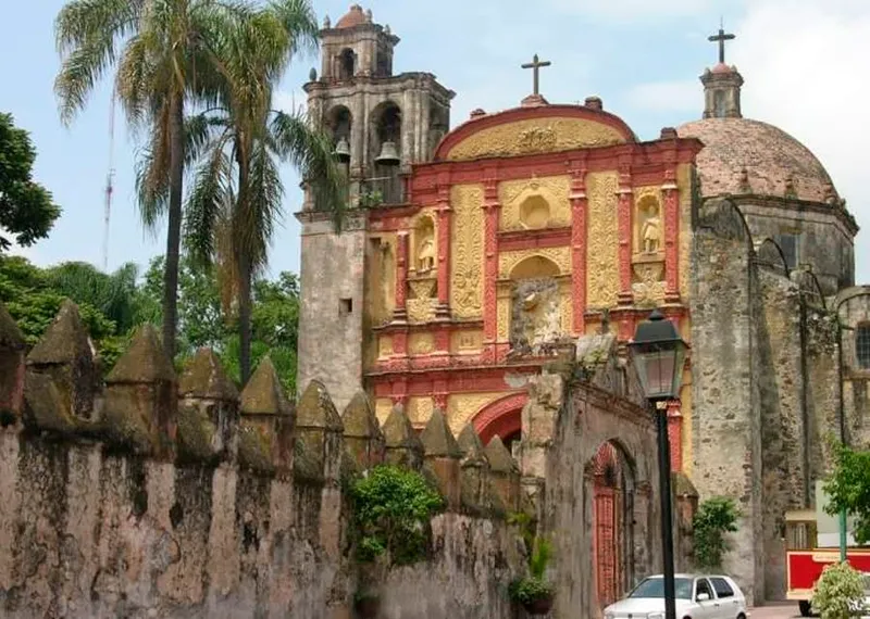 Cuernavaca cathedral facade and plaza trees in bright late dry-season sunlight