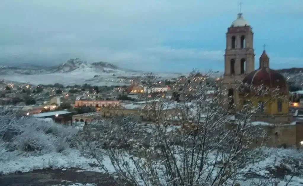 Snow-covered colonial rooftops and hills in Sombrerete, Zacatecas
