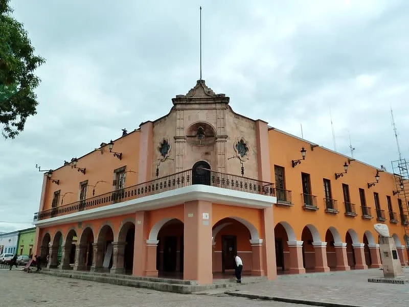 Colonial facade of Casa Abasolo beside the central garden and parish church