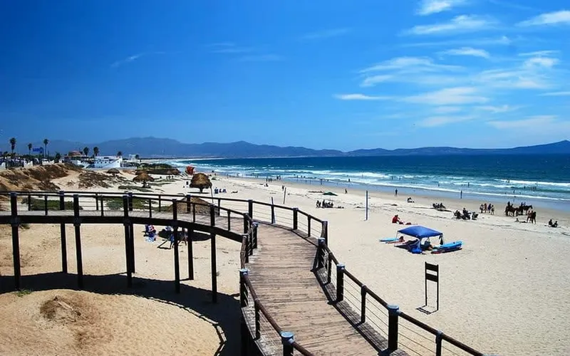 Sunny May beach near Ensenada with Pacific surf and a wide sandy shore