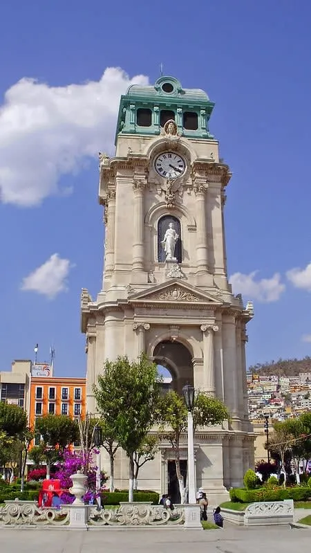 Large soccer ball sculpture beside a modern glass building