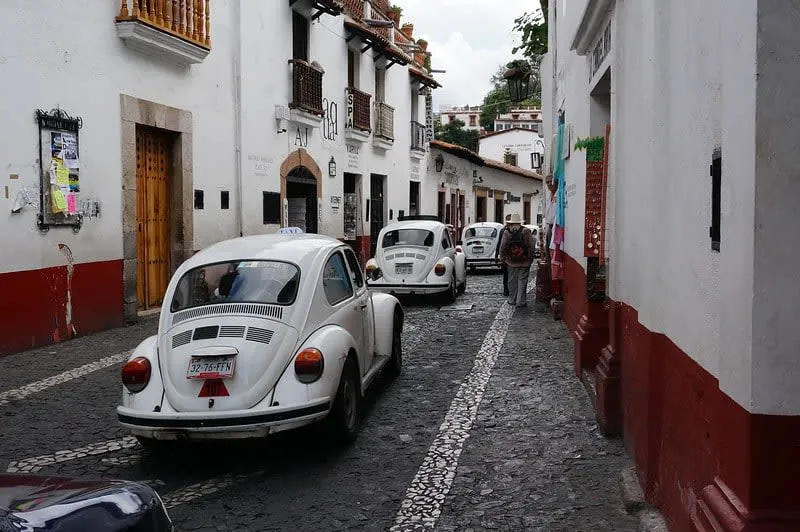 White hillside town with twin church towers and red roofs