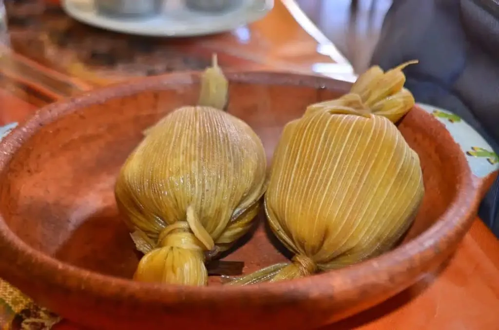 Tamales de bola from Chiapas wrapped in corn husks tied at both ends in the distinctive ball shape