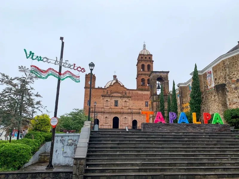 Guadalajara cathedral plaza with fresh green trees and clouds building over the towers